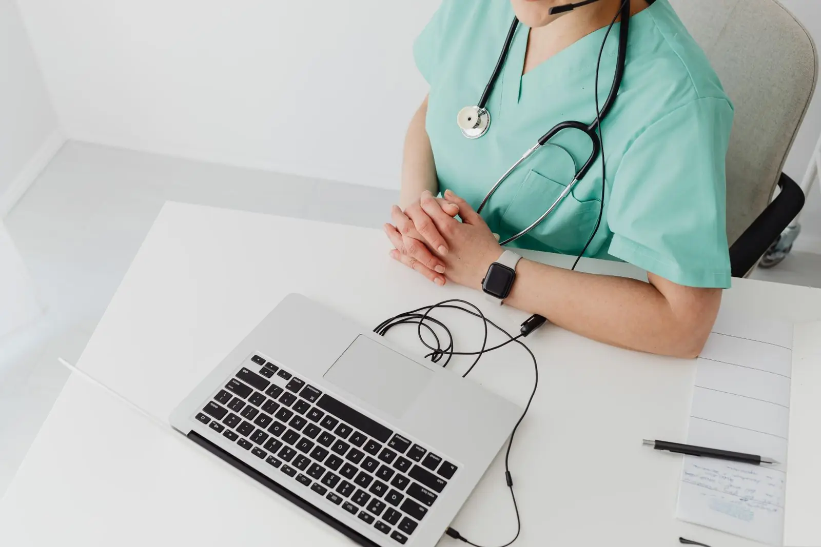 Clinician working on a laptop at a desk