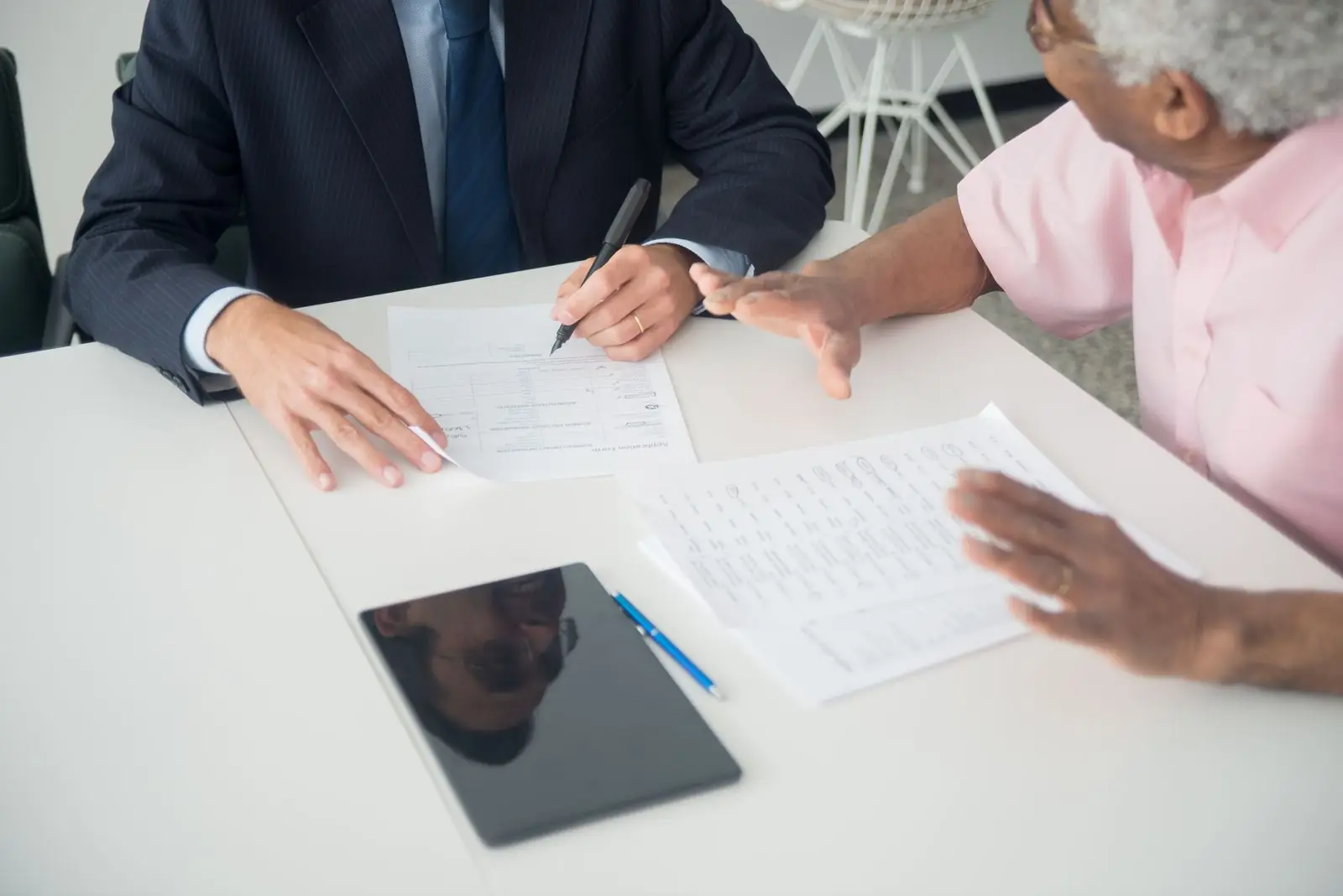Senior client reviewing documents with an advisor