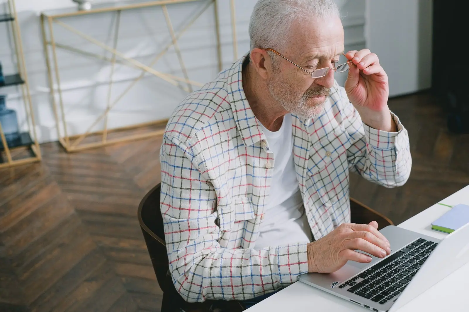 Executive in glasses organizing files on a laptop