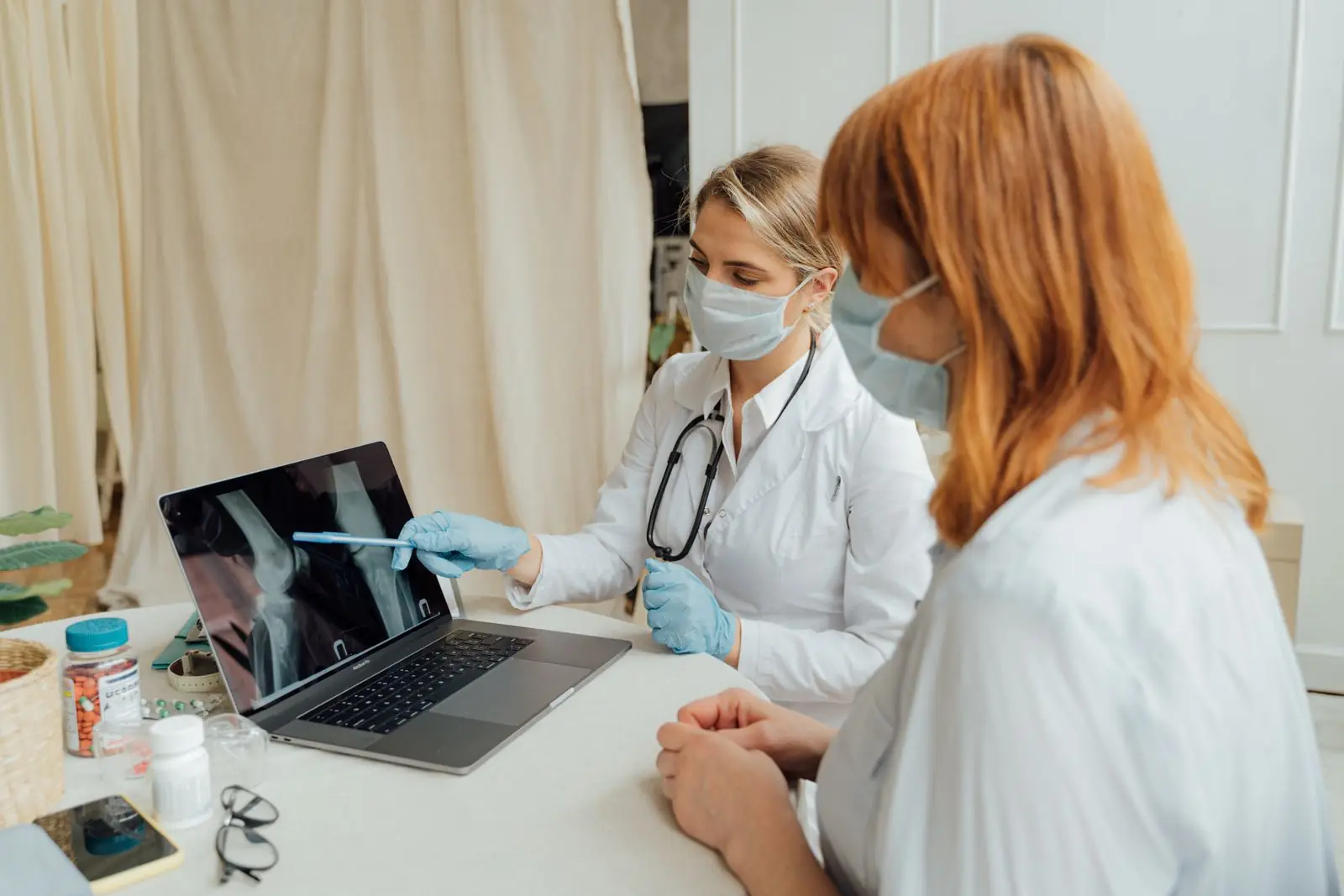 Doctors reviewing imaging on a laptop