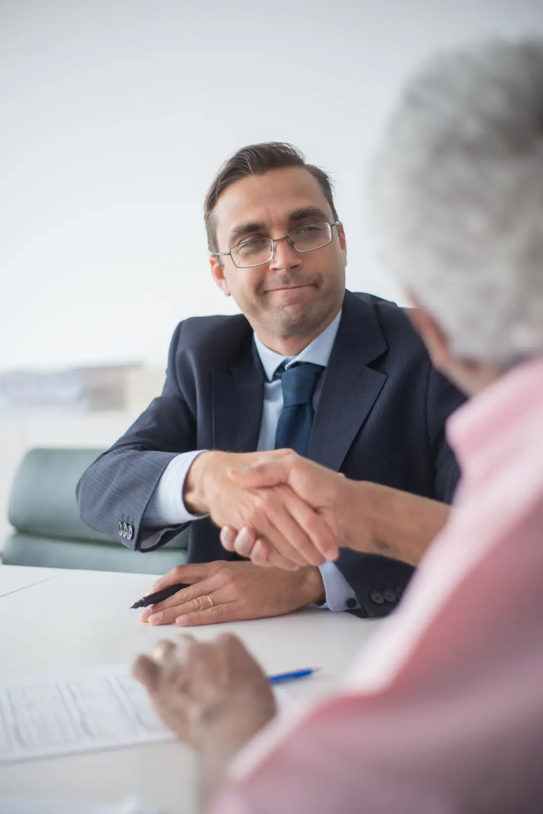Two businessmen shaking hands in an office