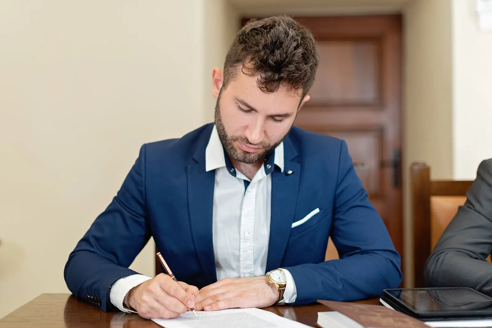 Business owner signing documents at a desk