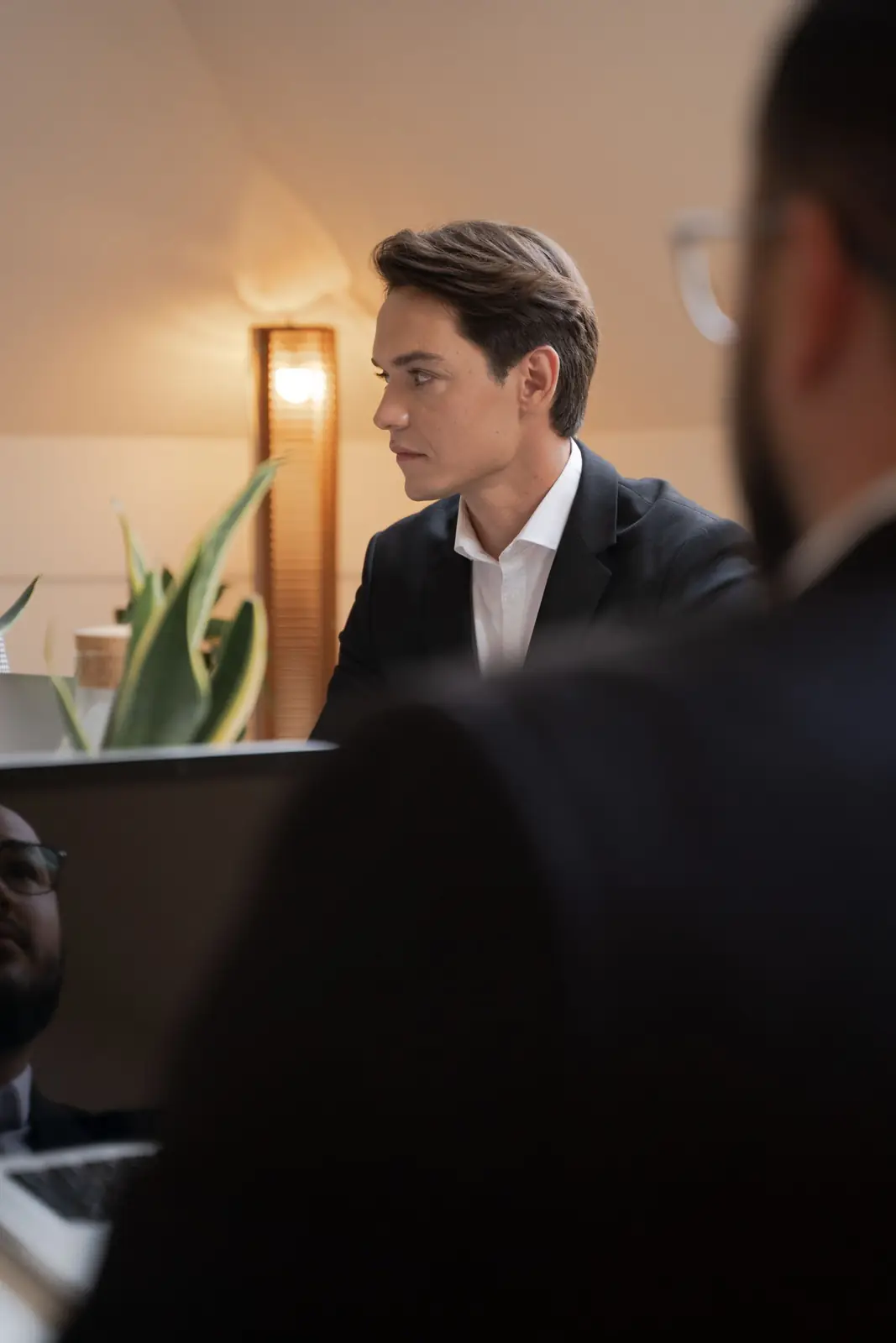 Executives in suits weighing a decision in a meeting